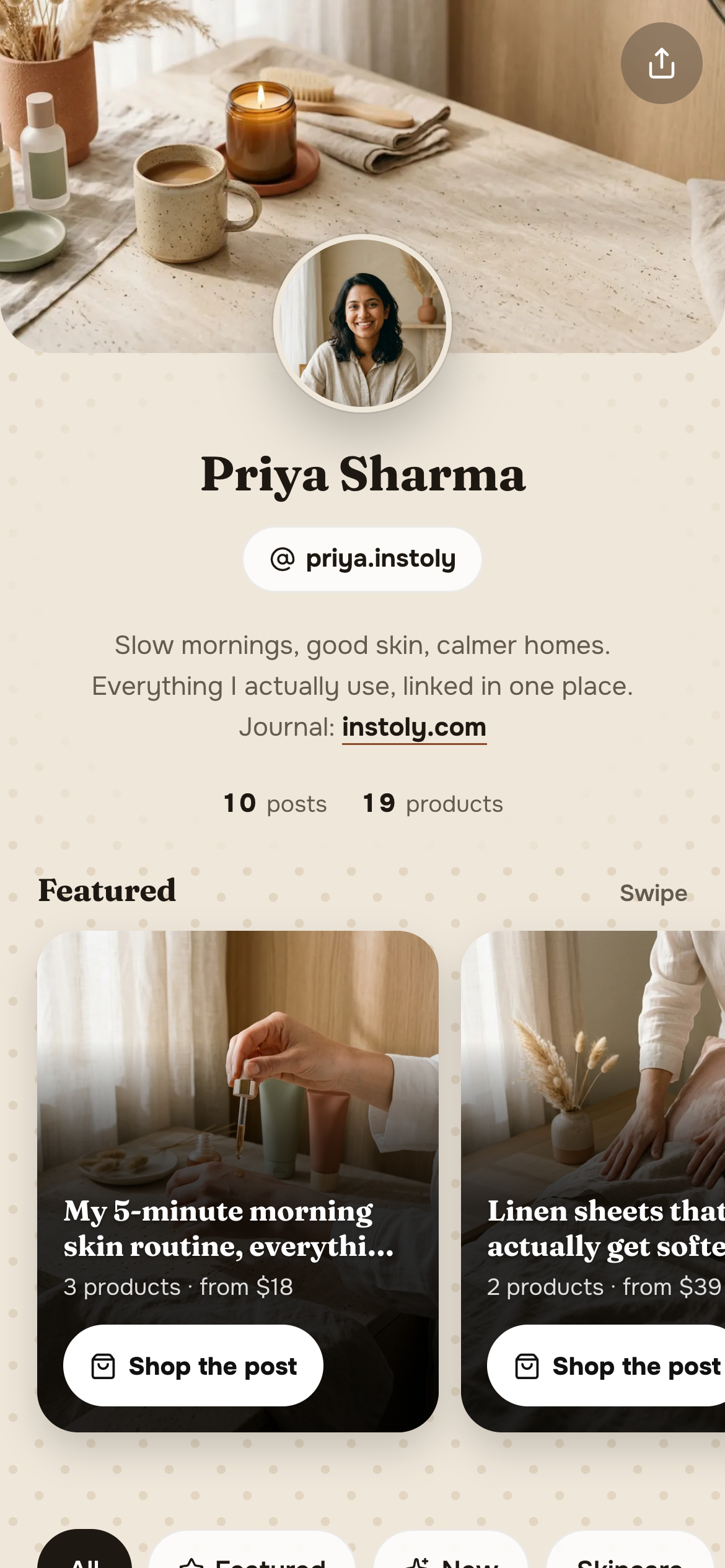 A store page on a phone, showing a banner, the creator's picture, name, handle and bio, and the start of the Featured shelf.